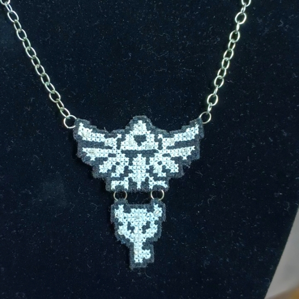 Handmade cross stitch silver Zelda Triforce and Boss Key necklace.